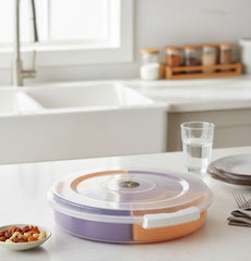 Colorful kitchen container on a white countertop with a sink and window in the background